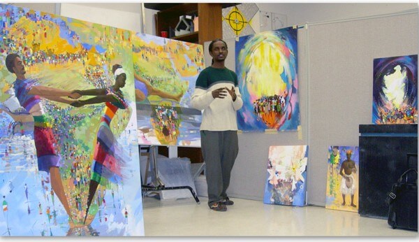 Graduate Student Presenting Painted Canvases