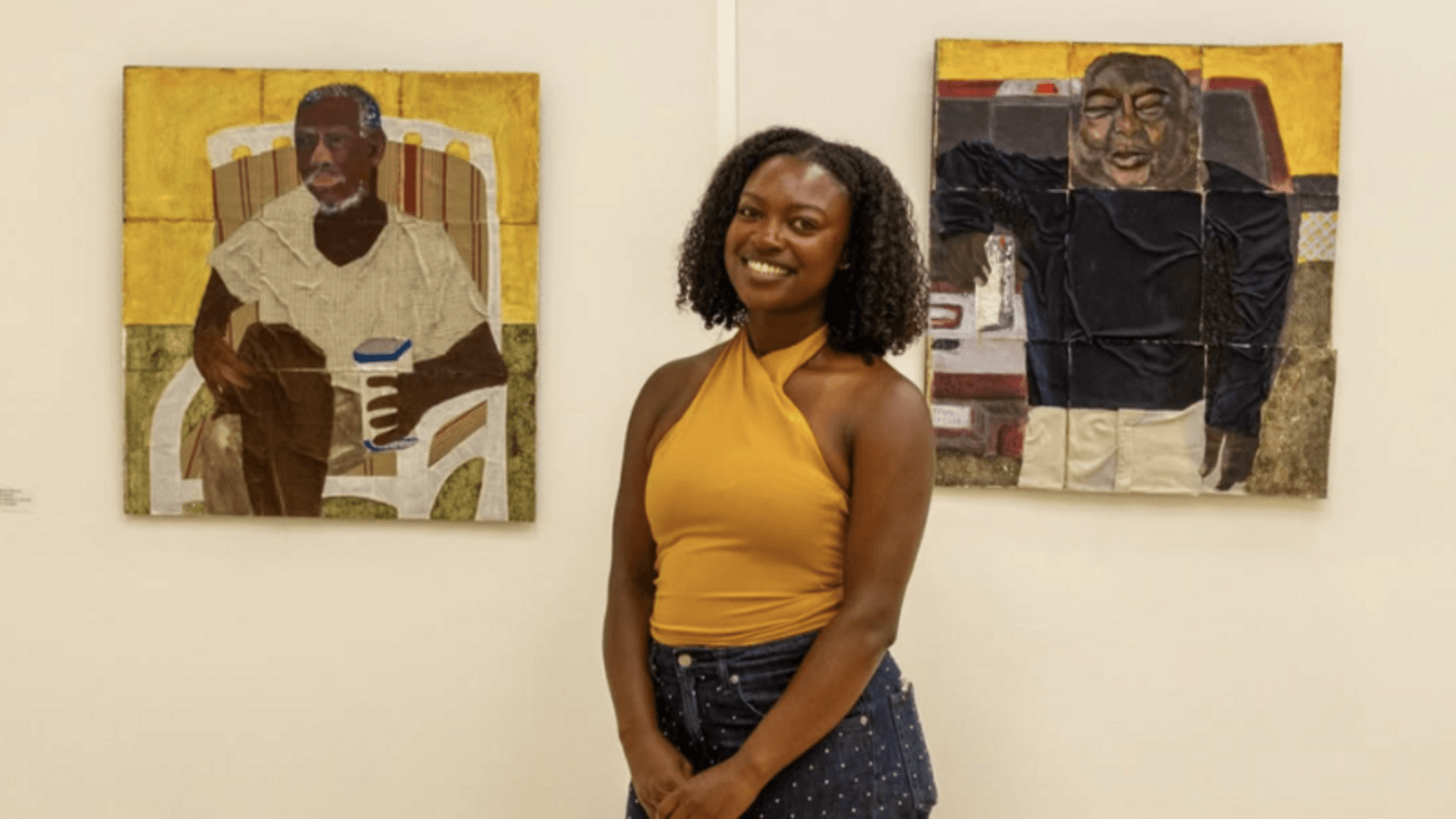 Mykayla Osborne poses in front of artwork