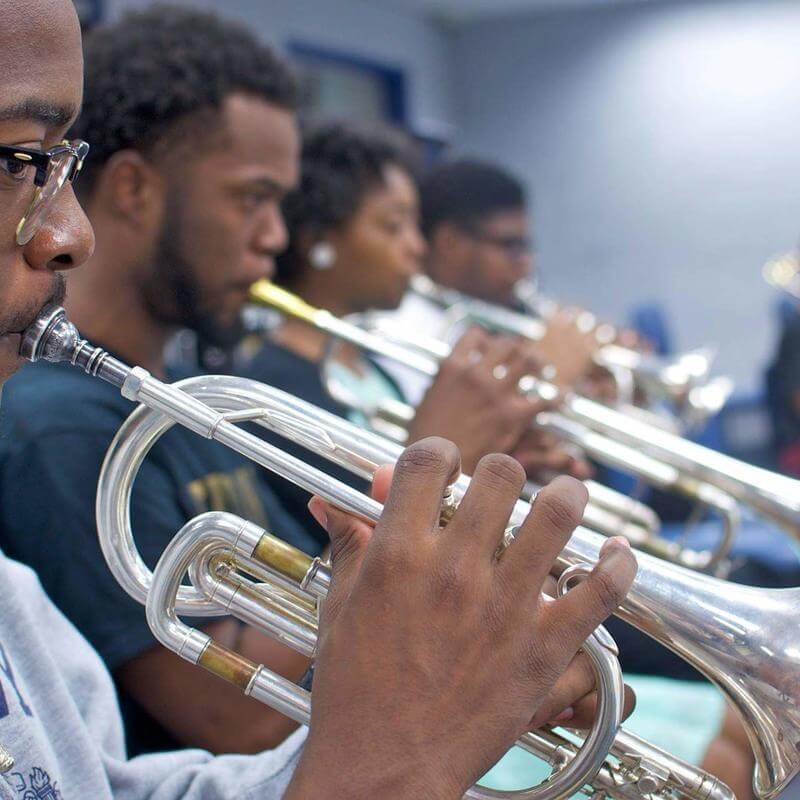 Brass instrument musicians practicing at the Department of Music.