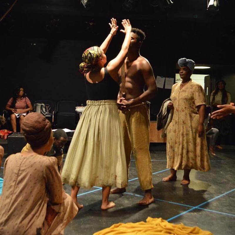 Howard University theatre students rehearsing in costume.