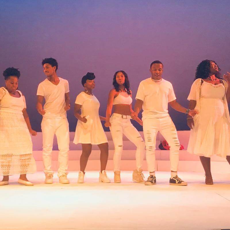 Howard University theatre students performing onstage.