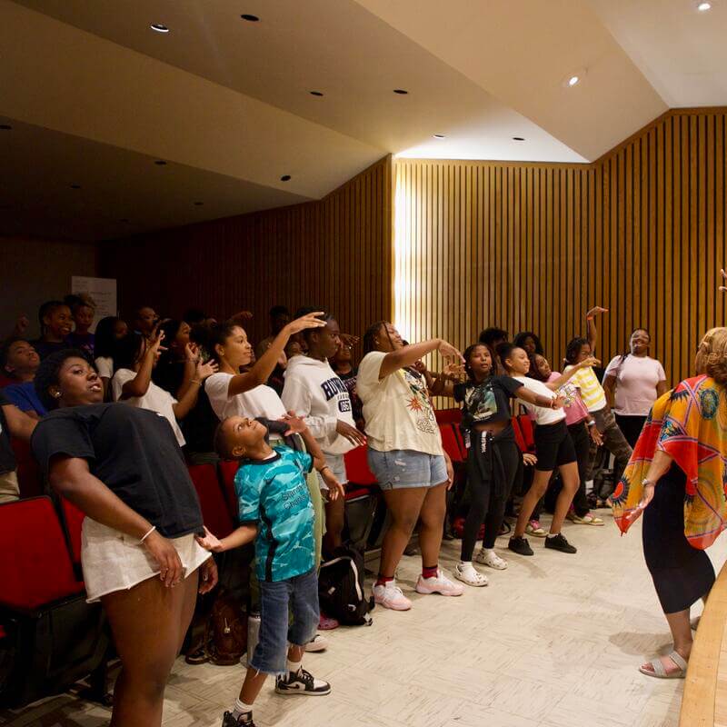 students on the recital hall in a voice class singing
