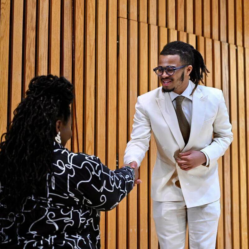 Student greets panelist