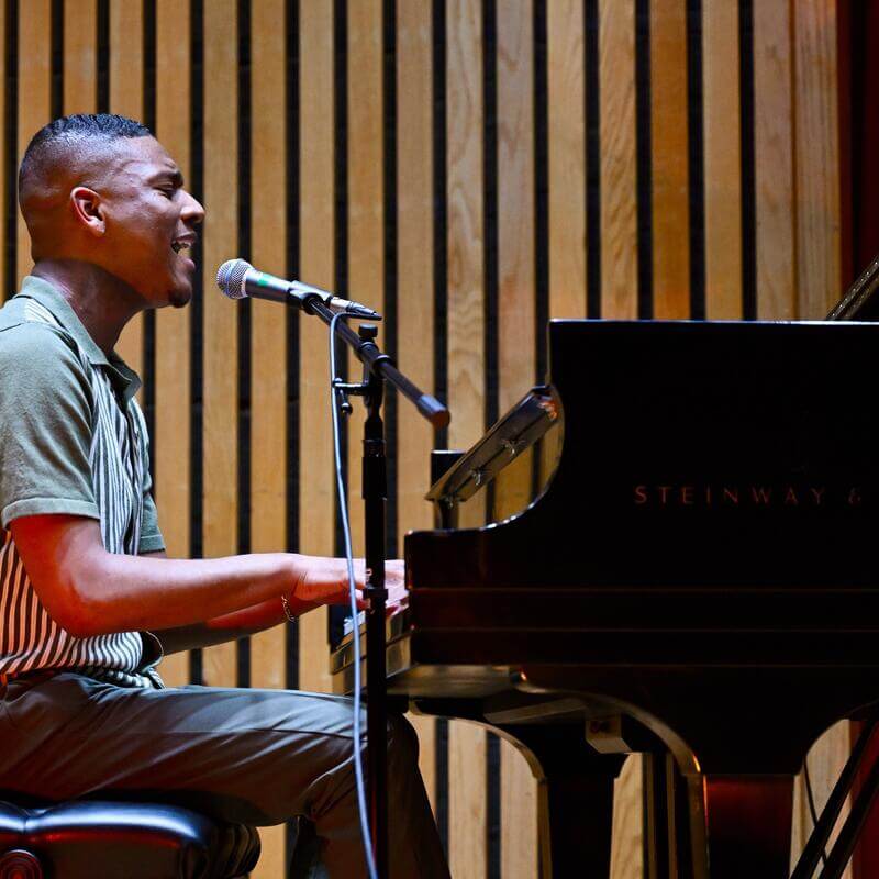 Student sings and plays piano
