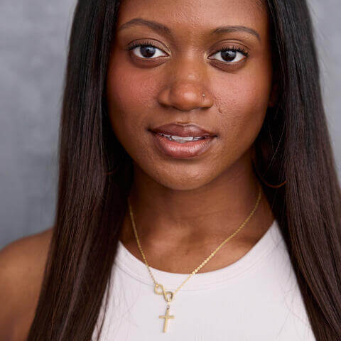 Morgan Tate, African American woman with long black hair and white shirt