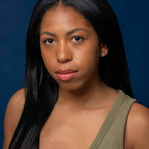 Quincy Willingham, African American female with long black hair and green shirt with no sleeves