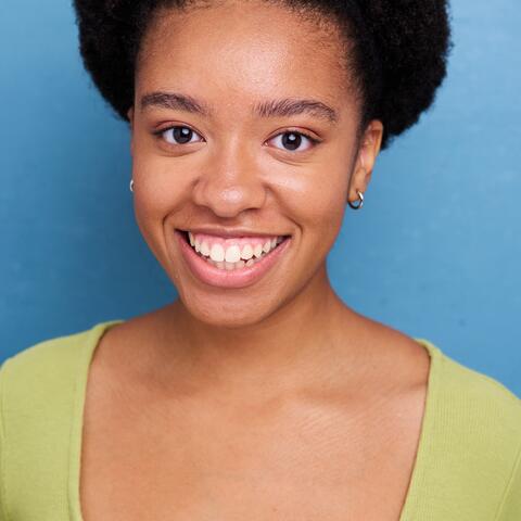 Ray Long, African American female with short curly afro and light green shirt