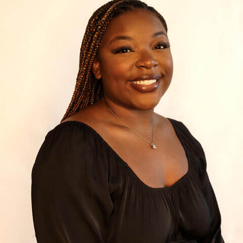 Rayven Williams, African American female with long golden braids and long sleeved black shirt