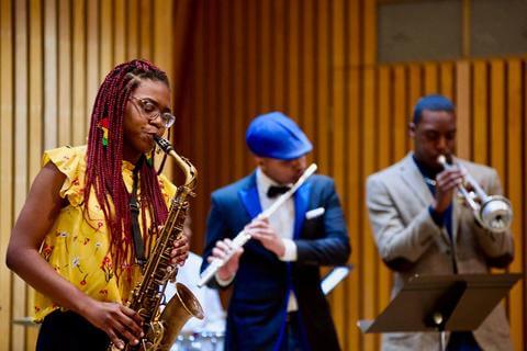 Three vocalists performing at the Department of Music.