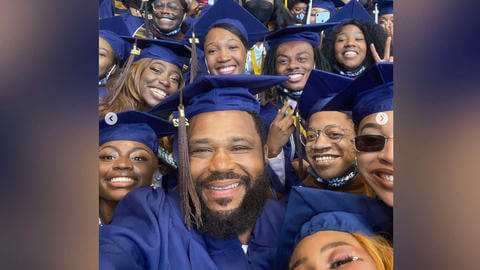 Howard U students at graduation with Anthony Anderson