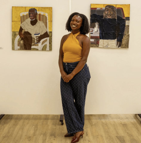 Mykayla Osborne poses in front of artwork