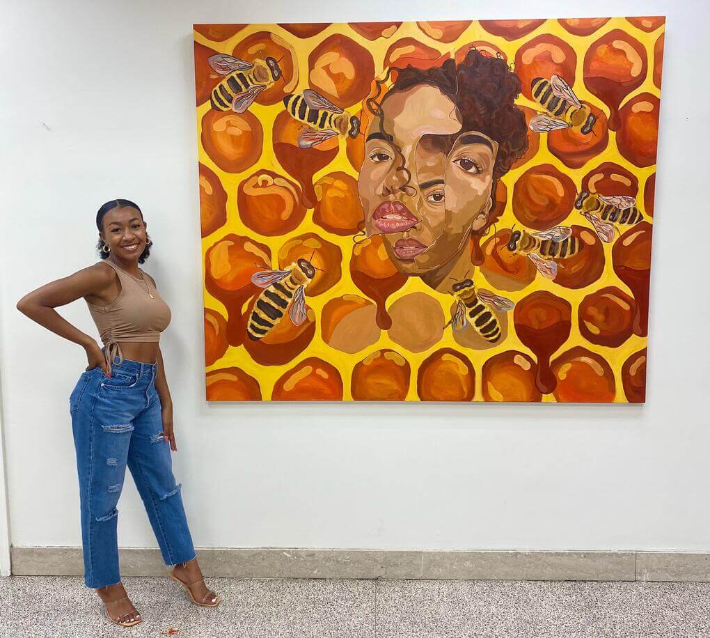 Kendall Robinson stands next to her oil on canvas piece entitled, "Metamorphosis"