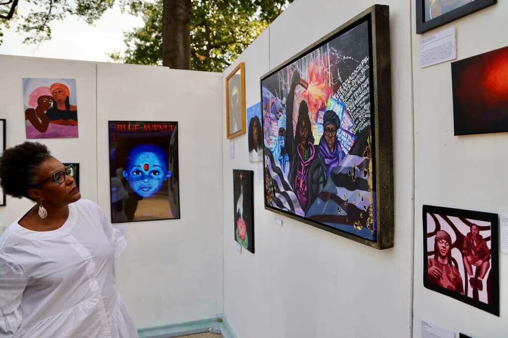 Dean Raquel Monroe takes in student artwork featured as part of the Chadwick A. Boseman Day visual arts showcase.